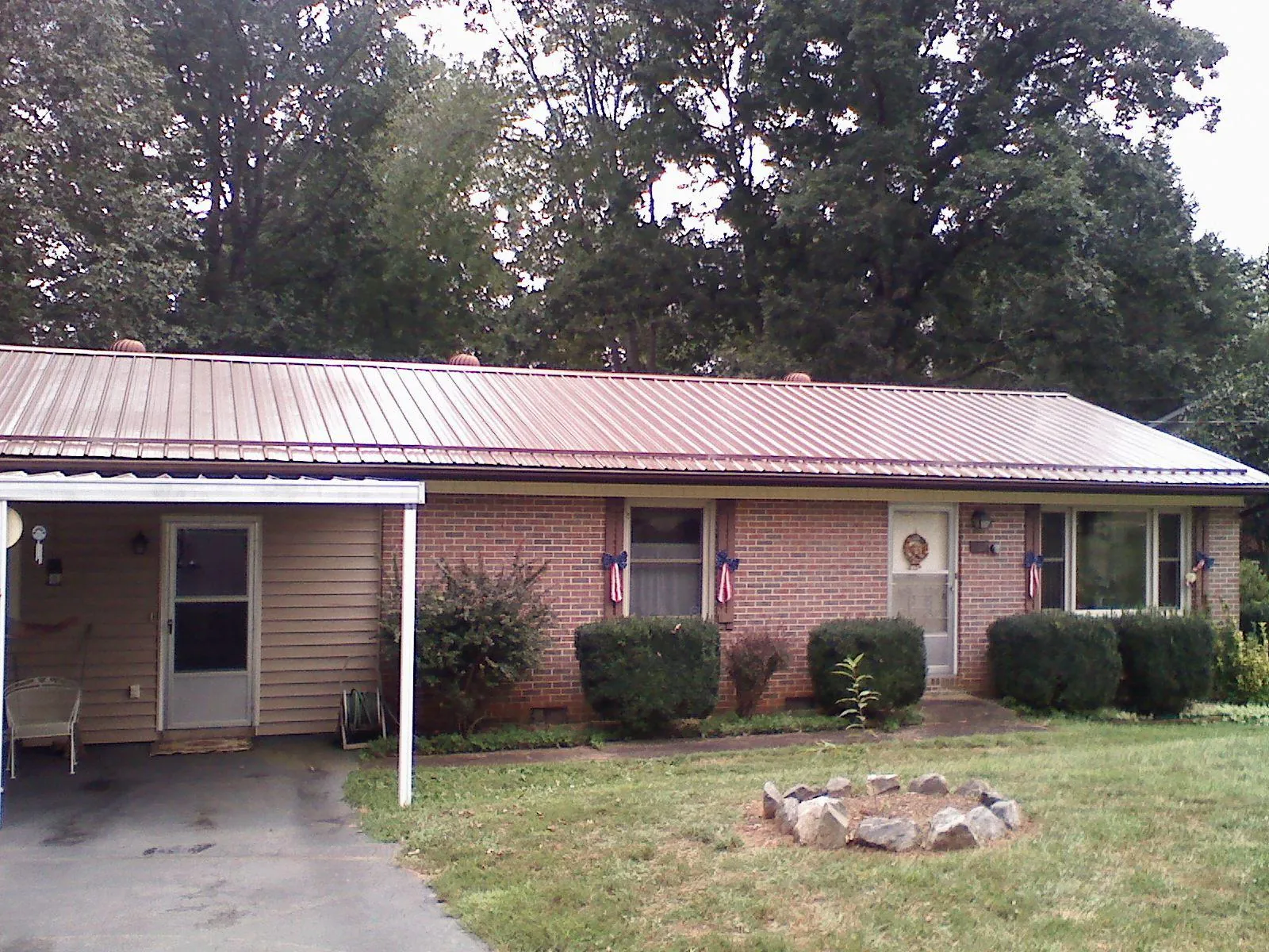 Bronze metal roof and carport on a brick ranch home — Roof Repair work by our crew in Blue Island